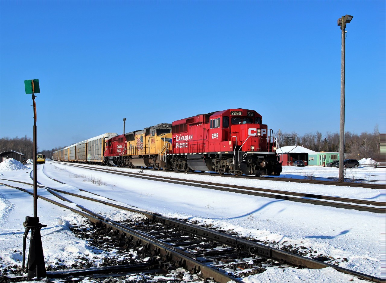 What a nice surprise to see the sun shining for a change around here and have a train running eastbound to take full advantage. A pair of GP20C-ECO's in CP 2269 and CP 2319, sandwich UP 3894 on their way through Guelph Junction with a very short eight car auto rack train.