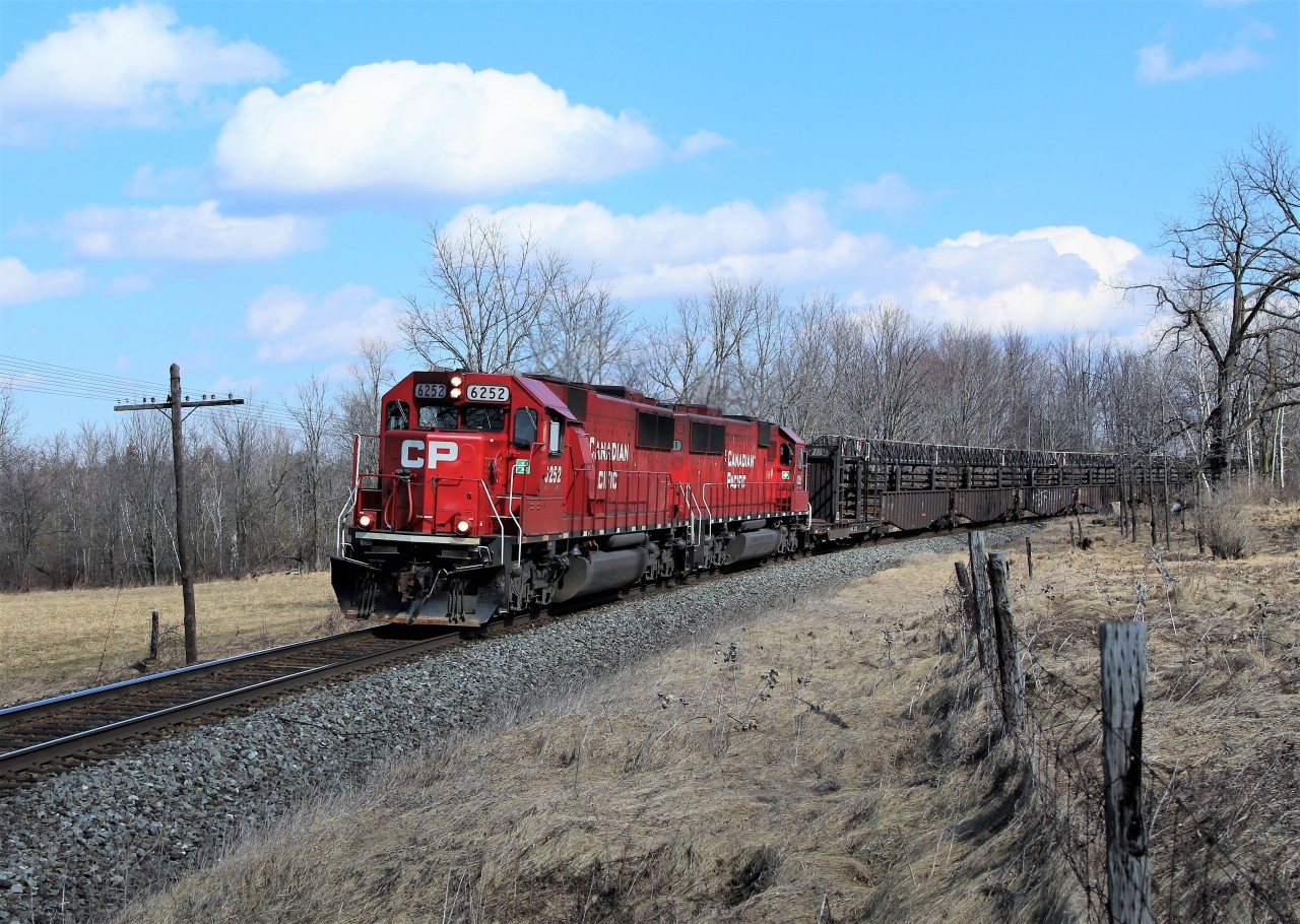 The sun poked out from behind the clouds just in time for the rail track train to roll around the bend with two ex-SOO SD60's for power in CP 6252 and CP 6251 on their way to Orr's lake siding.