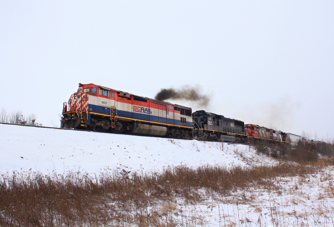 CN 372 pulls ahead in Belleville yard starting his work with a sputtering BC cowl, a IC SD70 and a pair of zebra geeps to be dropped off in the yard for running locals in the coming weeks.