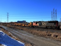 A continuous welded rail train makes its way east past CN Snider with a track warrant between Snider and Doncaster on main 1.