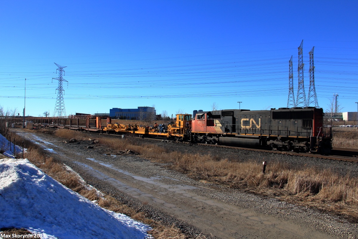 A continuous welded rail train makes its way east past CN Snider with a track warrant between Snider and Doncaster on main 1.