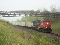 Once in a while you get extremely bored waiting for a CP train to come by the area and start looking at some of the older pictures you've shot. I don't remember shooting this but out of the light fog comes CN 2521, looking a little worse for wear, hauling the Triple Crown train up to MM30 on the Halton sub.