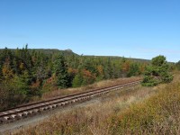 ALL THAT REMAINS. Just west of Avondale, lies the longest remaining stretch of the former Newfoundland Railway mainline. For 1.8 miles, this section of track survived the dismantling program thanks to the hard work of the Avondale Heritage Society who also managed to preserve the Provinces' oldest wooden station in that community. With the backdrop of the Blue Hills, the last official scheduled train to run past this area was Terra Transport Extra 944 East heading to St. John's with five NF210's, two gondolas of scrap metal and a caboose on a rainy September 29, 1988. A testament to the track crews is evident in the remarkable condition of the line a quarter of a century later, considering that no maintenance has been since that time.  