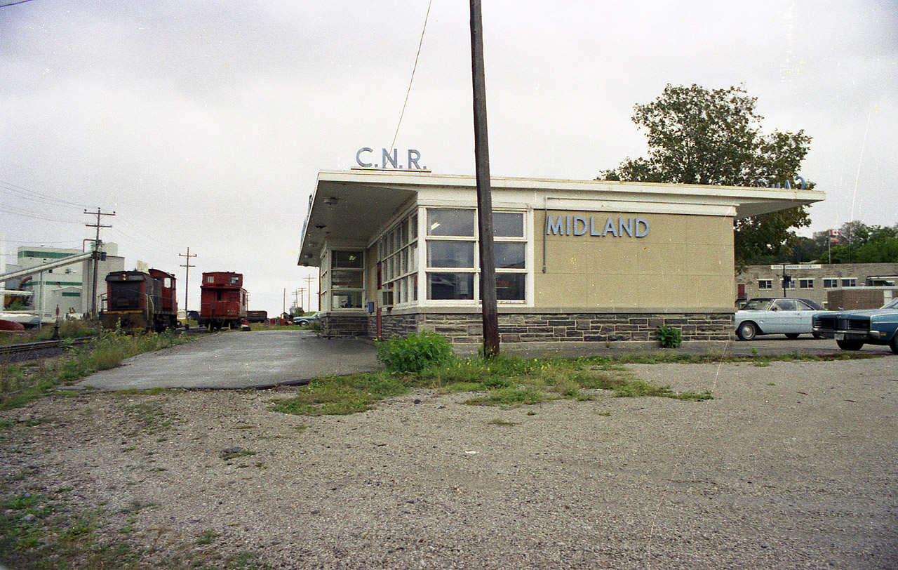 The former Midland Rwy reached its' namesake on Georgian Bay in the 1800s. The CN station pictured here is now gone, as is the track and everything associated with it.  In 1994 the "Rail Trail" was opened up along the old railroad route, as being done in so many localities. Midland Dock was the end of this line in from Orillia, and at one time a lot of Georgian Bay shipping went on here, mostly grain and lumber. In this view, CN 1206 and caboose wait out the now quiet weekend. I'm disappointed a big annoying pole is in the photo, but it could not be helped. Slightly too big for my clippers. :o)