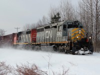 On a very cold winter day, GTW SD40-3 5951 kicks up the snow, at St-Paulin, along with GP40-2L(W) 9543, pulling 69 cars