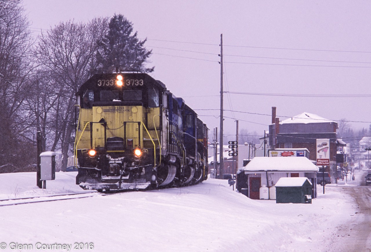Enroute from Ontario to Nova Scotia for Christmas I have spent the morning shooting the Canadian-American around Farnham while snow steadily fell. I have made it a bit further down the road to Richmond in time to catch the departure of SLR #394. They normally had to double over a number of tracks so you got a few chances at the leaving town shot!
