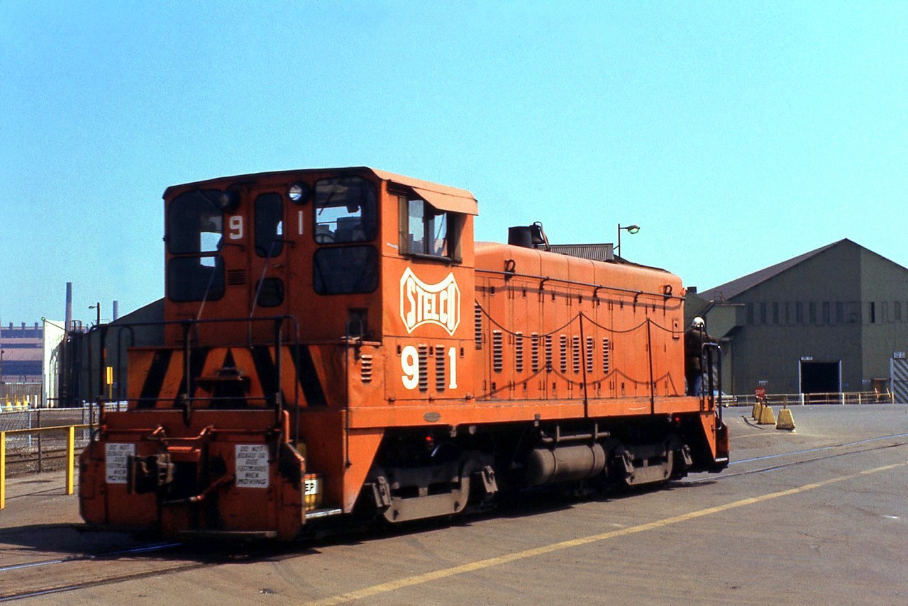 Stelco SW900 91 is seen here switching outside their plant in Hamilton in May 1974. Built by GMD London in 1965, 91 was one of a number of GMD SW's acquired in the 50's and 60's for switching Stelco's in-plant trackage around their facilities, and came equipped with a low profile cab roof line for work around areas with restricted and tight clearances. Many things have happened in the years since, including Stelco's purchase by US Steel, and the recent name change back to Stelco.