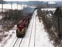 A TH&B "Rock Extra" always got the fans worked up. Here is a classic run with TH&B 72, 73, 57, 51 and 55 working hard to climb the escarpment to Vinemount. I'm standing on the road-bridge where old Hwy 20 passes over the tracks; a place now that is off-limits to train watchers. I suppose one could still venture to this location, but parking has been removed, barriers are up, the road is 4 lanes of heavy traffic, and getting to finish off your days on this green earth as roadkill is an extreme possibility. There were a number of rock trains in the 80s, heading to Port Maitland for the most part, and the very sparse TH&B roster was squeezed to the limit, resulting in yard switchers assisting to ensure the train made it with fewer problems to the crest at Vinemount. Then excess puller-power returned to Kinnear. This head end consists of two GP7s, and two SW9s with an NW2 (#51) between. The #51 went to the OSR in Salford back in 1992. They still have it.