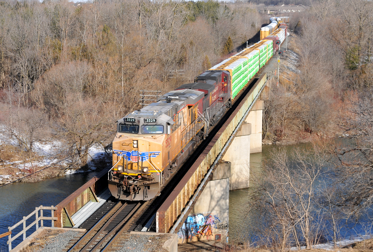 235 arriving at Woodstock to make a tail end lift from Coakley with UP 5529, and CP 9783 up front