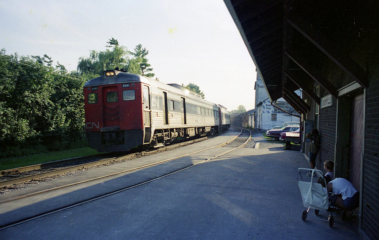 Budd Cars used to be so common. I was not much of a fan of them. But now, I kinda miss them. They have been away from the Southern Ontario scene since around 1990. This view shows the evening train from downtown Toronto rolling in to a stop at the quaint Unionville depot, on its way to end of its' run at Uxbridge. It is a tough angle, this shot, as it is 1808 and the sun is setting behind the old elevator next door on the other side of the parking area. Budds are: 6351, 6001, 6006 and 6401.  CTG says the 6006 is now at Orangeville.