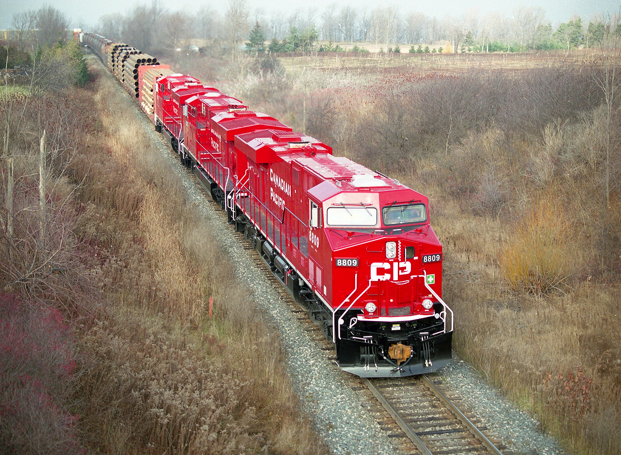 The sun was in and out of the cloud on me as I tried to grab a decent shot of this #256 cresting the hill at Vinemount; new paint made for an attractive set of locomotives. Seeing how filthy most GEs were, efforts to capture something like this was all that more worthwhile. Granted, the GEVOs were treated with a much better coating than the old 9500s, et al, but still; there is nothing like New.  CP 8809, 8813 and 8812 were alive barely a week  when this photo was taken.