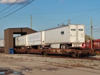 An Xpressway 5 pack gets serviced at a car repair shed in the yard. Stored engines are off to the right.