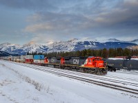 The sun had set behind Whistler's Mountain in Jasper, AB for the day, however, with a cool sky hanging over the Colin Range and a cool set of power bringing in the once a week Memphis-Prince Rupert train Q197, I decided to snap a shot. CN must have faith in these old girls, as C40-8s 2130 and 2105 were put to task to lead this 12258' monster across the country.