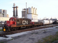 CN 7258 switches cars in the small yard on the "farm track" in Sarnia, Ontario. This yard was used to store cars for Royal Polymers and Cabot Carbon. The Royal Polymers SW800 switcher 8620 can also be seen in the background. Royal Polymers closed with the plant demolished and the little switcher sold elsewhere. 