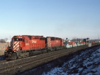 CP5532-CP5728 have just crossed Winston Churchill Blvd (Mississauga, Ont) and are about to crest the grade out of the Credit River valley at Mile 25 Galt Sub.  When I lived in this area I was able to see the track at the Mile 25 detector out of the back window of my house. Westbounds were usually moving slow enough I could beat them over to Hornby. Then they built another housing subdivision behind me and blocked my view. So I moved.