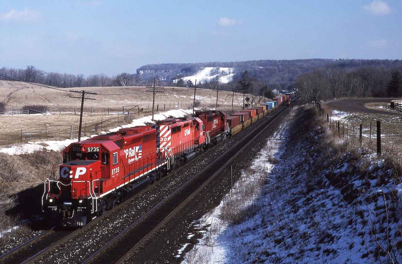 CP5735-CP6030-CP6034 lead train 507 around the Niagara Escarpment approaching Guelph Jct on Feb 16th 1995. If you nicely asked the owner of the horse farm he would allow you to drive on his property to get to the wooden bridge for this shot.