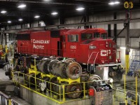 Ex SOO SD60M CP 6258 poses by stacked General Electric AC traction motors while having some repairs performed.