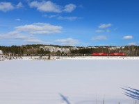 CP U58 skirts by a snow covered pond on its way from Levack to the Clarabelle Mill.