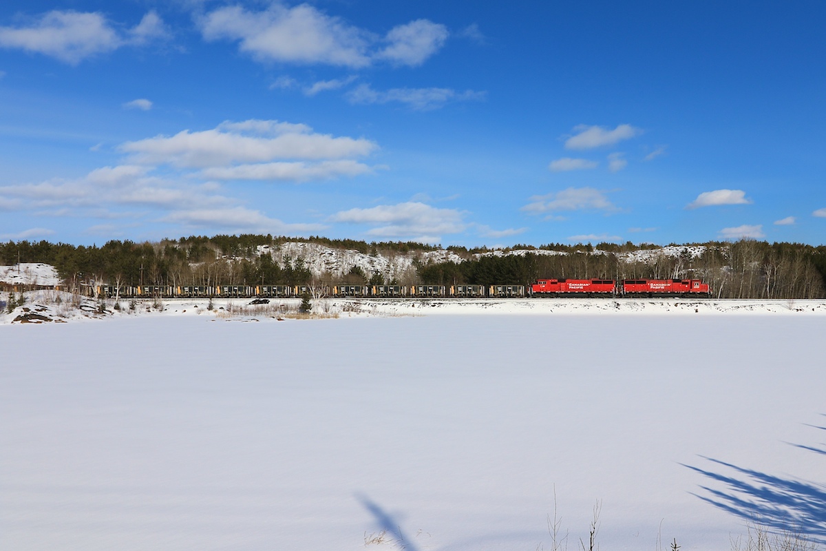 CP U58 skirts by a snow covered pond on its way from Levack to the Clarabelle Mill.