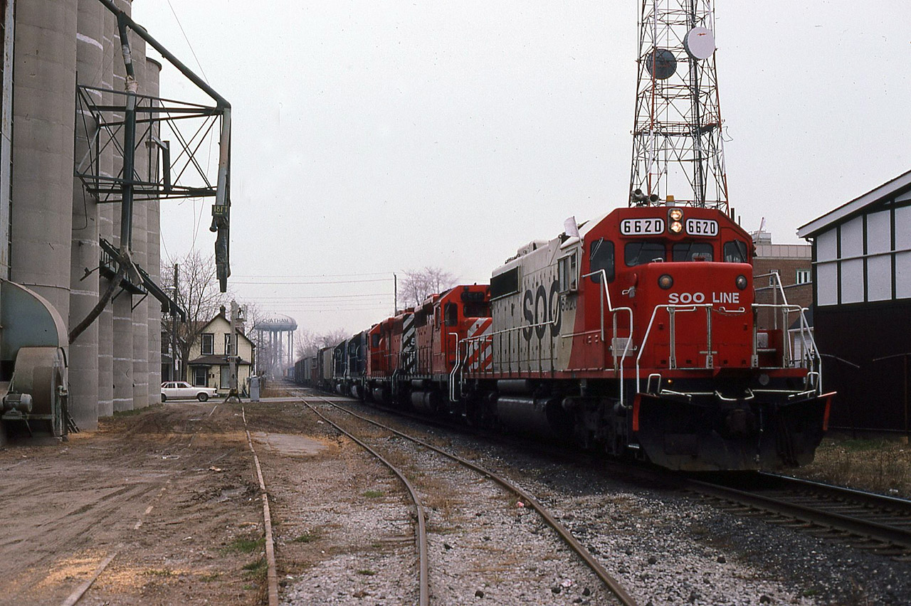 I don't have the dates pinned down but I believe sometime in mid- to late 1985, CPR began operating what was described as "SOO business" via Montreal/Chicago routings and numbered the trains 500-501-502-503 ( at least). Anyway here's eastbound 502 at Center Street in Chatham as he cuts the city in half during his passage. SOO 6620 is leading CP SD-40's 5546 and 5528, which in turn are hauling dead, leased GATX power SD-40 5081 and 5073 still in Missouri Pacific paint. In 1987 CPR leased 10 of these units from GATX Leasing but this was the only time I caught them on film. They were enroute to Toronto or Montreal for placement in service. Trains 501 and 502 were usually daytime passings in the Chatham area, so I did shoot them a few times (between work and family etc). This elevator, whose name I've long since forgotten, is no longer in existence.