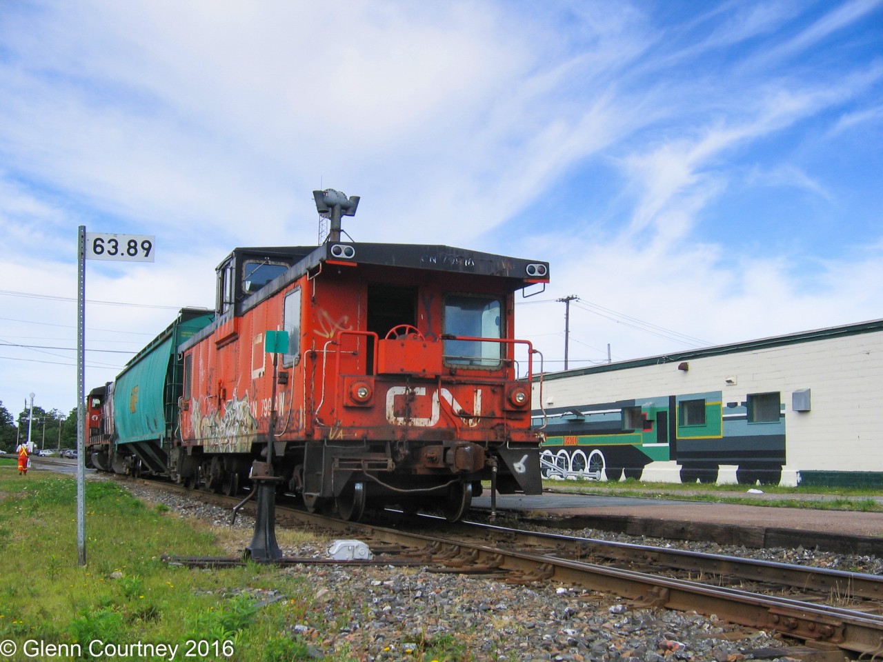 CN 515 is pulling out of the siding across from the station and heading east to do some switching at one of the feed mills on the east side of town. Looking in on the action is the CN 6401 mural on the wall of the shopping centre that replaced CN's station.