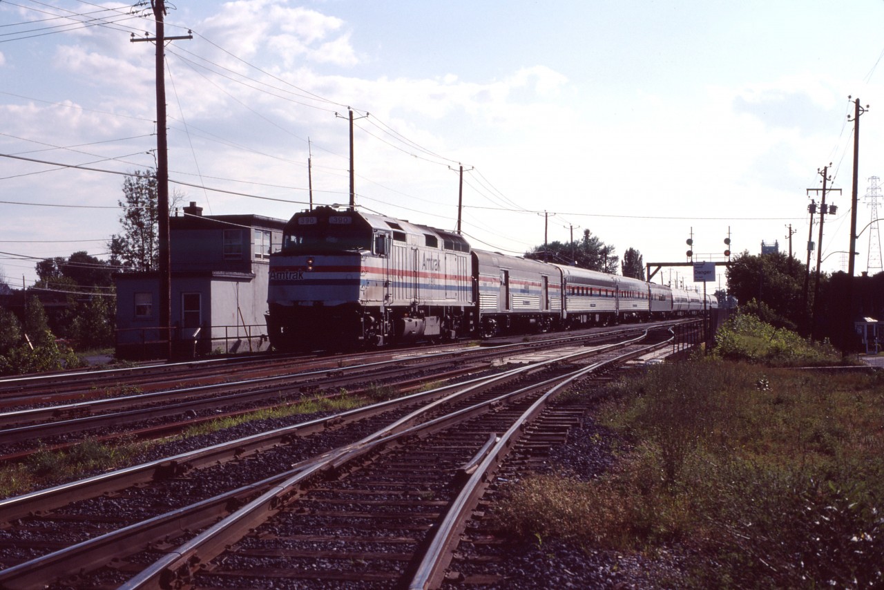 Between 1972 and 1995 (with a suspension between April 1987 and July 1989), Amtrak operated an overnight train between Montreal and Washington . Here we see one of the first runs of the restored southbound "Montrealer", making its suburban St. Lambert stop. Train No. 624 (its number on CN lines) is operating with a then-ubiquitous F40PH and eight cars--what appear to be a baggage car, two sleepers, meal/lounge service, and four Amfleet coaches. The train would be cut back to St-Albans, Vermont and changed to a daytime schedule in April 1995.