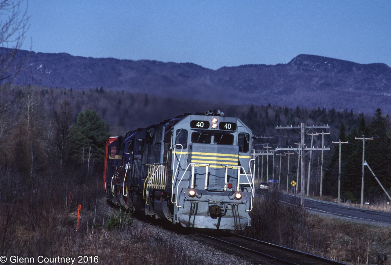 I had never shot the CPR line to the Maritimes while it was under CPR control but made a number of trips to photograph the action during the Iron Road era. Eventually they had a fleet of repainted locomotives in a scheme patterned after CPR's maroon & grey scheme. Early on though CDAC 40 was the only locomotive on the property in the corporate scheme so it was great to get it leading.

If things went according to plan you could pick up an eastbound in the early morning out of Farnham or Sherbrooke and chase it to Megantic and then wait around for #901 to show up. In 1997 track speed was not subject to the many slow orders that would come so chasing could be a challenge.