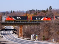 CN 570 rolls over Church St. with some recently repainted power.