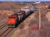 CN 373 rolls through Bowmanville with a veteran leader. Still earning its keep, the 4806 was added onto the head end at Brockville after the BCOL unit succumbed to major issues. 