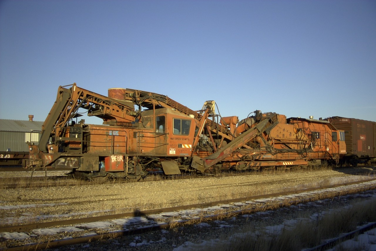 A major component of keeping the roadbed clean and able to properly drain is ballast undercutting. Back in the 80's, 90's and 2000's, CN had several Plasser RM-76 UHR ballast undercutters across the system. CN 50553, s/n 203, built in 1981 is seen here sitting in the Transcona Work Equipment Yard after a long season of undercutting, waiting its turn to go through the shop for necessary repairs before once again heading out for another work program.