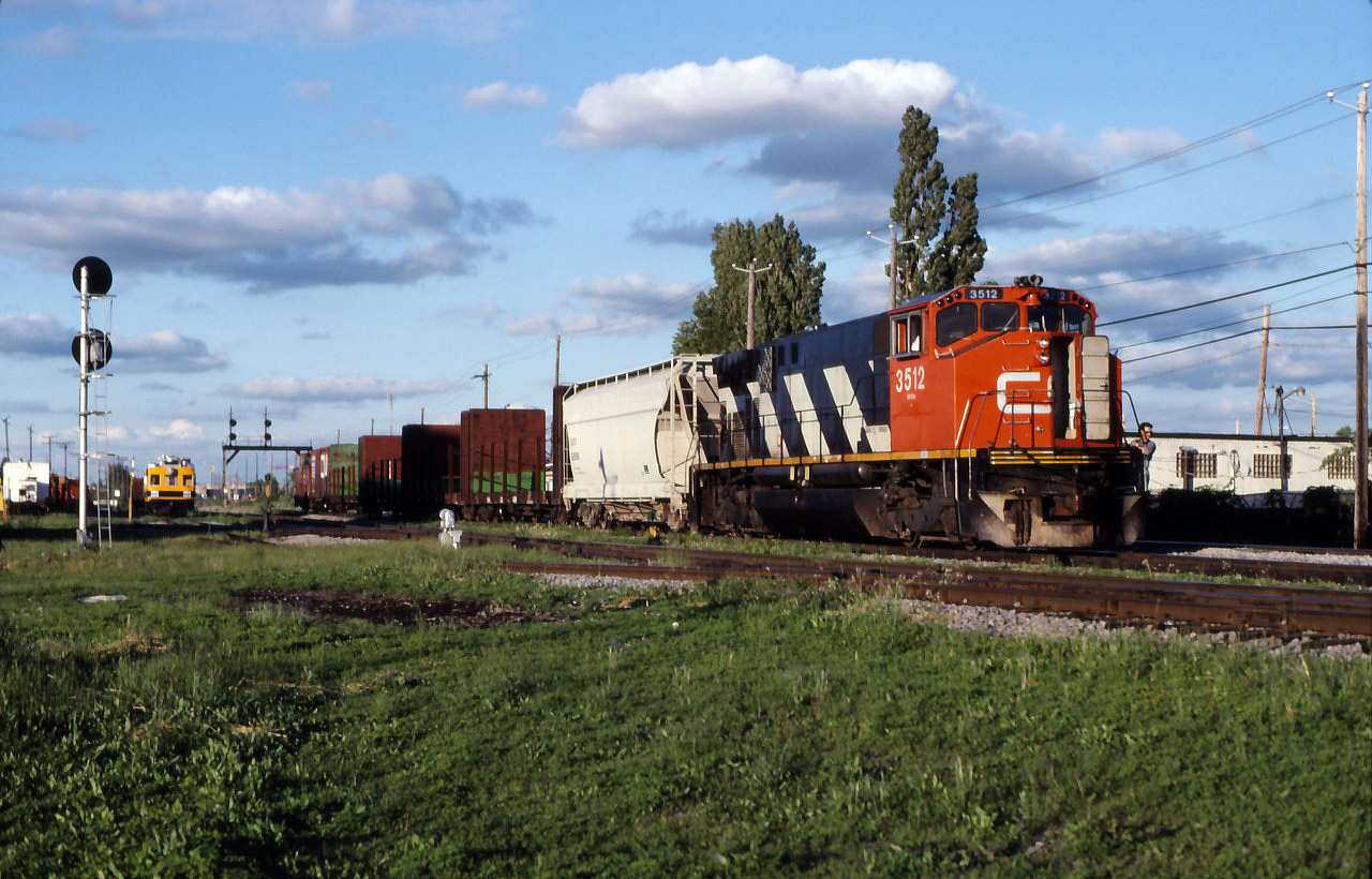 CN 528, the LaPrairie local, returns to its home base in St. Lambert on a beautiful evening in June 1990.