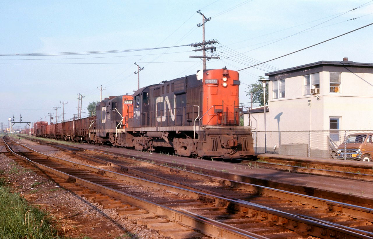 A westbound freight passes the St. Lambert interlocking tower as exits the south passing track, possibly having worked Southwark Yard. CN RS18 3740 leads GP9 4489 in this undated photo taken early in the summer of 1974.