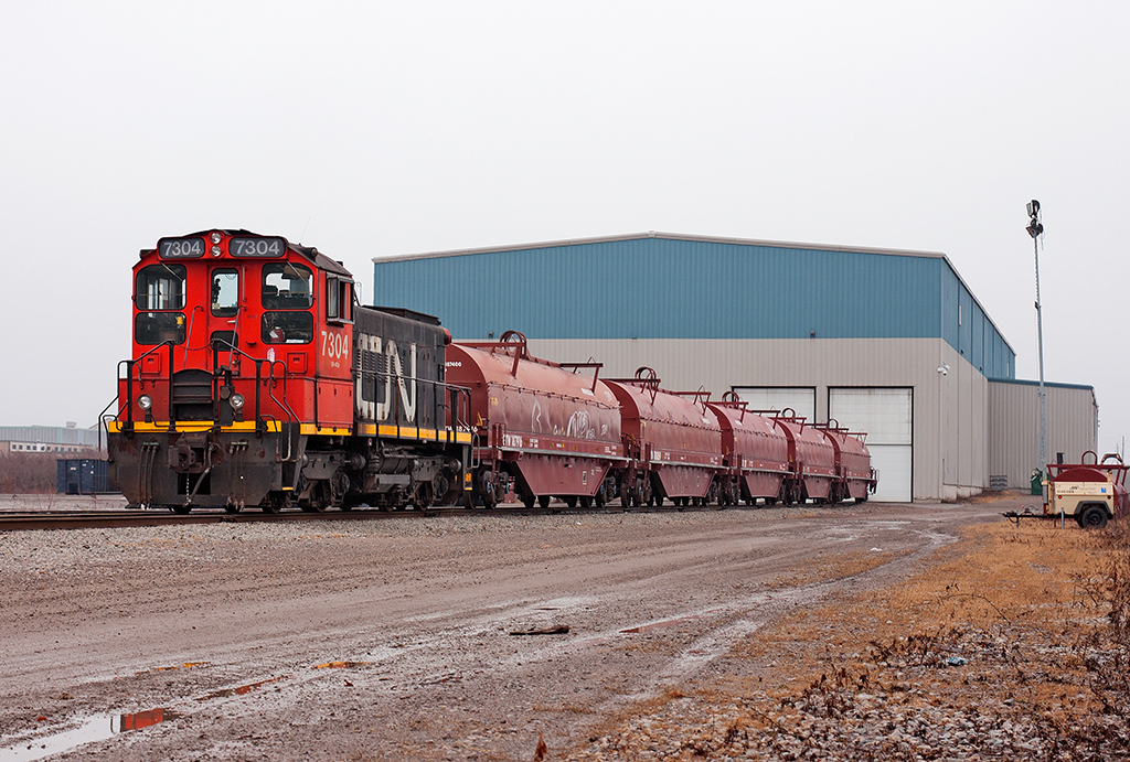 Spending the day idling away, CN 7304 now resides at the steel center shuffling around rail cars.