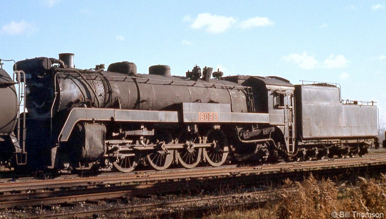 Canadian National U1b-class Mountain 6028 (built by CLC in 1924) is shown in the Stratford scrapline in 1959, not long before it would meet the torch. 6028 had been used to pull the 1939 Royal Train, thus the wide number side panels along the running boards. During those duties, it also wore crowns on the front running boards (a la what CP's Royal Hudsons had) and a royal crest in place of its number plate under the headlight.