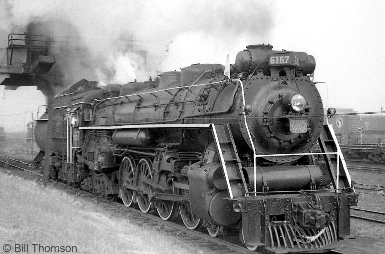 Another photo of Canadian National 6167 (U2e Northern), her tender heaped high with coal, at Mimico Yard's concrete coaling tower in early 1960. At the end of the steam era, CN was approached by the UCRS about a steam engine for excursion service, and 6167 was selected as the best of the remaining Northerns based out of Mimico (most stored serviceable at the time).