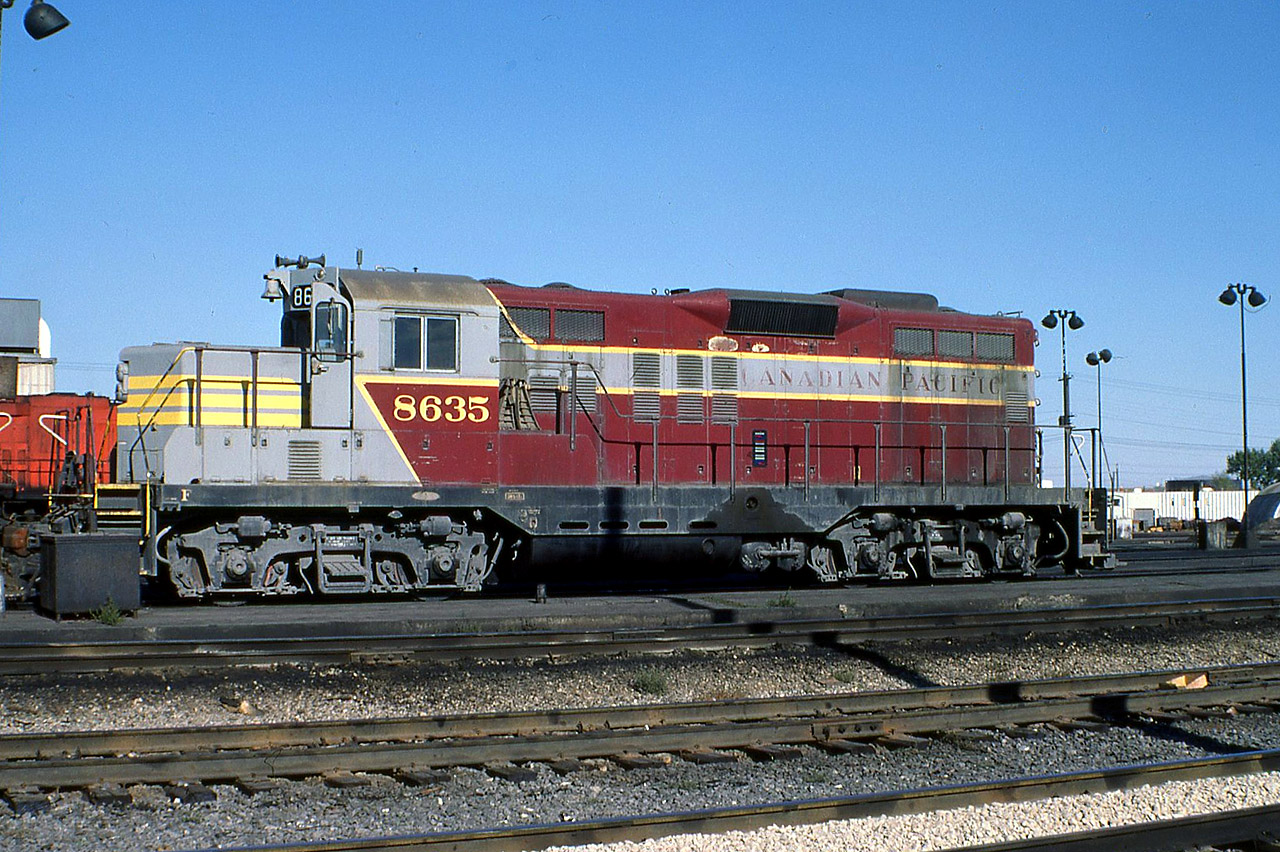 CP GP9 8635 taken sometime in 1975 by unknown photographer.
In 1971 CP put three geeps through Ogden shops, Calgary and without upgrading them or repainting, simply chopped their noses. The other two, 8633, 8634, remained in red with the multimark, and in the script (respectively).
In the later rebuild program, these 3 were completely rebuilt and emerged as 1576 (8633), 1579 (8634) and 1580 (8635). The 1576 and 1580 were " trade-ins" for the CP GP20ECO program and were cut up; but 1579 still exists at Viterra, Kindersley SK renumbered 1319.