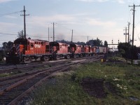 During the "Oka Crisis" in the summer of 1990, both CP and Conrail diverted trains over CN lines. Here we see a CP eastbound with five rebuilt RS18s passing CN's St. Lambert Station in the early evening.

This train was interchanged with CN at Parsley (next to Cote St. Luc and Taschereau Yards). I'm not sure where it returned to CP lines (Delson or Sherbrooke?) and would appreciate any insights from other RailPictures.CA members.