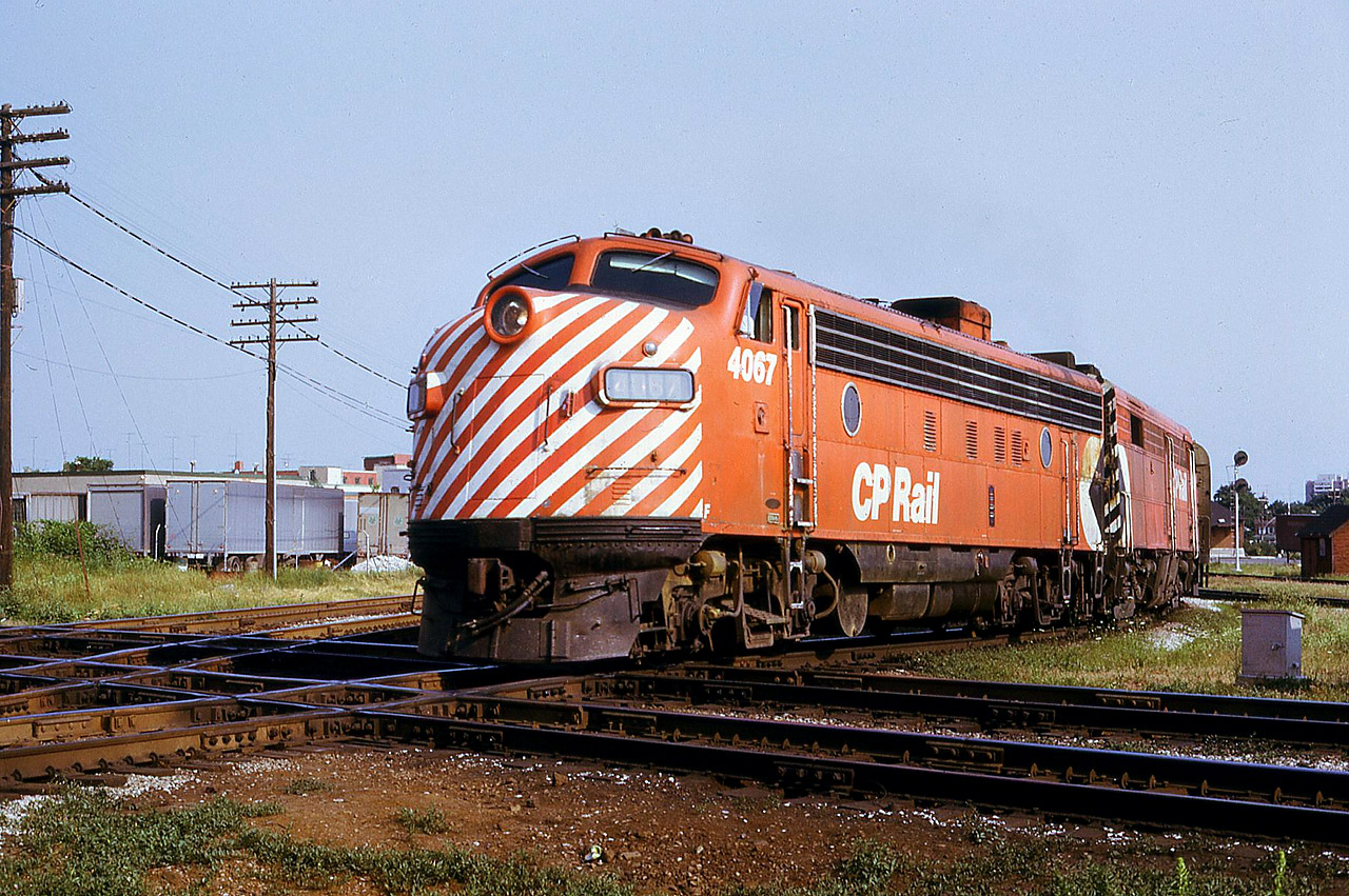 CP FP7 4067 along with FPA-2 4096 take the Toronto portion of THE CANADIAN, train 11, across the West Toronto diamonds in the summer of 1973. I worked 330pm-1130pm at CN West Toronto for approximately 6 months that year, so on slower days ( weekends ) I usually brought the camera. I would say this is a Sunday train since that day was the slowest and allowed me time to walk a few hundred yards to the diamond. I took this shot as No. 11 pulled away from CP's West Toronto station ( background, right) and started it's journey to Sudbury. Not long after, the 4067 was temporarily repainted for the ficticious company AMROAD and used ( along with 4070) in the movie SILVER STREAK starring Gene Wilder and Jill Clayburgh.