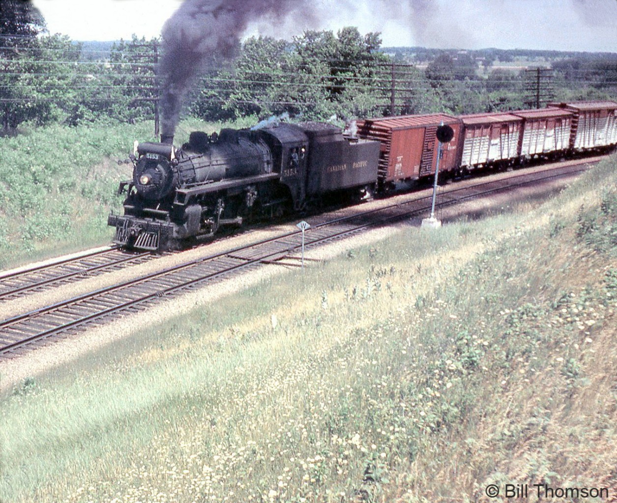 Canadian Pacific P1e-class Mikado 5153 climbs the Niagara Escarpment on the Galt Sub near Kelso (present home of the Kelso Conservation Area, although this part of the Galt Sub was "Christie" on CP's timetables) in July 1959. This train is a bit unusual as there's no assist helper engine today. An assist pool was based out of Lambton (the "Cockney Pool" as many used to call it) for the 60-mile Toronto to Orr's Lake run, and an assist engine was usually tacked on front of the train's main power to help with the grades.