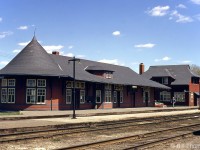 Canadian Pacific's Orangeville Station, built in 1907 and still in pristine condition, is shown next to the bunkhouse at Orangeville Yard in April 1971. It was closed and moved off-site in the 1980's to serve as a restaurant along Broadway, leaving the bunkhouse for railway use here under CP and later the Orangeville Brampton Railway.
<br><br>
Unfortunately the bunkhouse burned down in a fire in March 2006, but OBRY has since built its own scaled down station on site for use by the Credit Valley Explorer tourist train based out of Orangeville. GO Transit also presently uses the parking lot here for their commuter "Park And Ride" lot for bus services.
