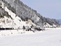 The Société du chemin de fer de la Gaspésie's windmill train slowly snakes along the Restigouche river, near its terminus of Matapedia where interchange with the CN will take place.
