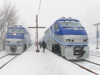 In the midst of a fierce and windy snowstorm, commuters make their way to AMT 89 for Candiac, on the right. At left AMT 1327 leads the deadheading AMT 91, which will leave for Candiac at 1755.