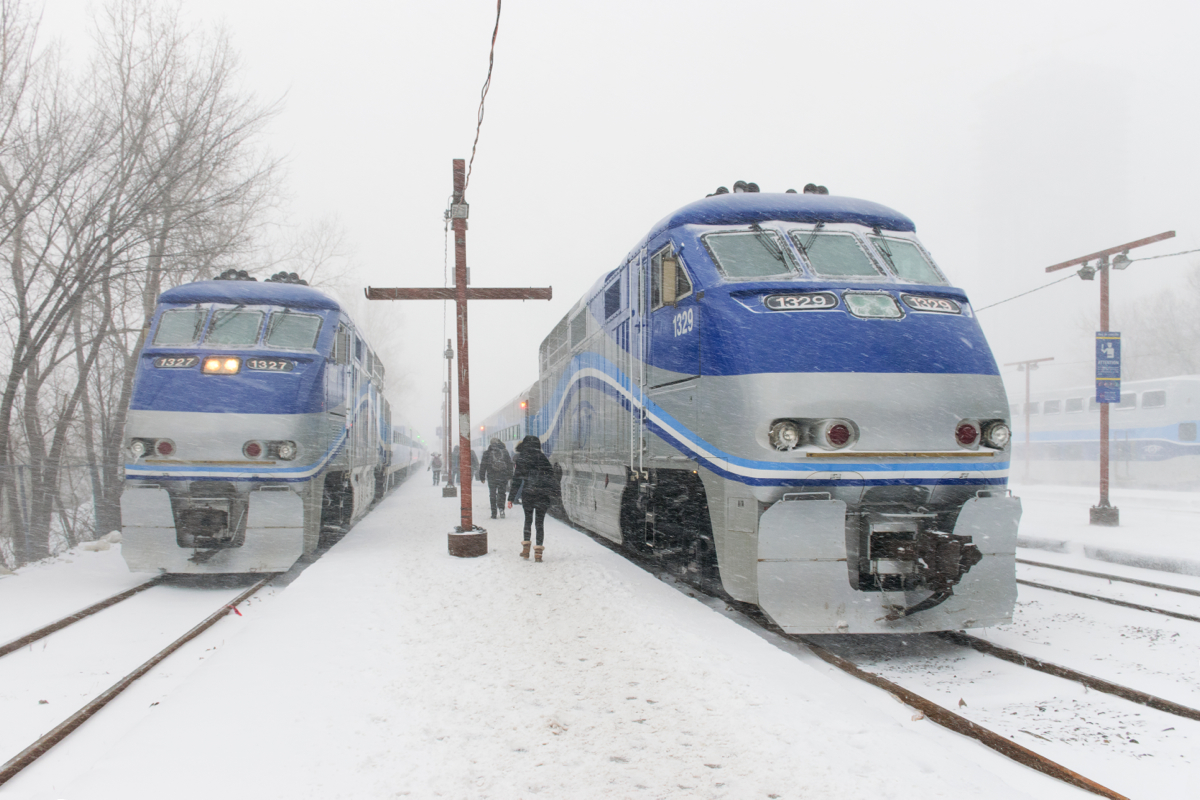 In the midst of a fierce and windy snowstorm, commuters make their way to AMT 89 for Candiac, on the right. At left AMT 1327 leads the deadheading AMT 91, which will leave for Candiac at 1755.