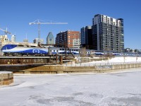 Bombardier ALP-45DP AMT 1367 pushes the 6 Bombardier multilevel cars of AMT 809 past Peel Basin on a sunny winter morning in Montreal.