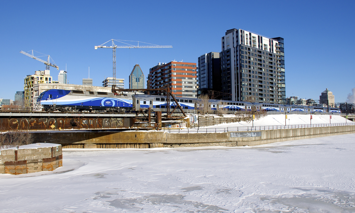 Bombardier ALP-45DP AMT 1367 pushes the 6 Bombardier multilevel cars of AMT 809 past Peel Basin on a sunny winter morning in Montreal.