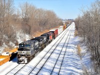 <b>NS power all over the place in Eastern Canada.</b> NS power enters Montreal on a daily basis on run-through train CN 529 (aka CP 931, aka NS 31T) but that NS power is sometimes used on other trains, and today must have been a record example, with NS units leading CN 407 in Nova Scotia and CN 327, CN 461 and CN 527 in the Montreal area. Here CN 527 approaches Taschereau Yard with NS 9293, NS 8981 & CN 2673.