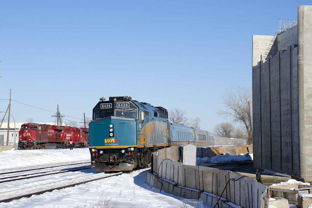 VIA 67 with VIA 6426 leading is about to stop at Dorval Station. At left is CP 119 (with CP 9350, CP 2278 & CP 8844), which will also be heading west shortly. At right is a new overpass which will soon go over the CN and CP tracks here.