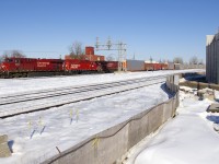CP 119 is slowly starting to pull from Dorval with CP 9350, CP 2278 & CP 8844 for power on a beautiful winter afternoon. In the foreground is CN's parallel Montreal Sub and at right is a new overpass which will soon go over the CN and CP tracks here.