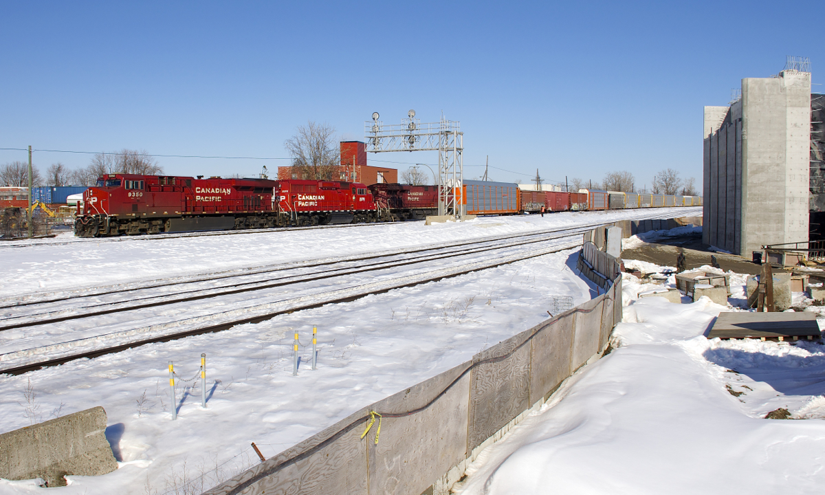 CP 119 is slowly starting to pull from Dorval with CP 9350, CP 2278 & CP 8844 for power on a beautiful winter afternoon. In the foreground is CN's parallel Montreal Sub and at right is a new overpass which will soon go over the CN and CP tracks here.