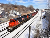 CN 2115 is looking very clean as it teams with CN 8848 to bring a 98-car CN 393 through Montreal West the day after Montreal got a decent amount of snow. On the long hood of CN 2115 is an illustration commemorating the 15th anniversary of CN being privatized, which took place in 1995.